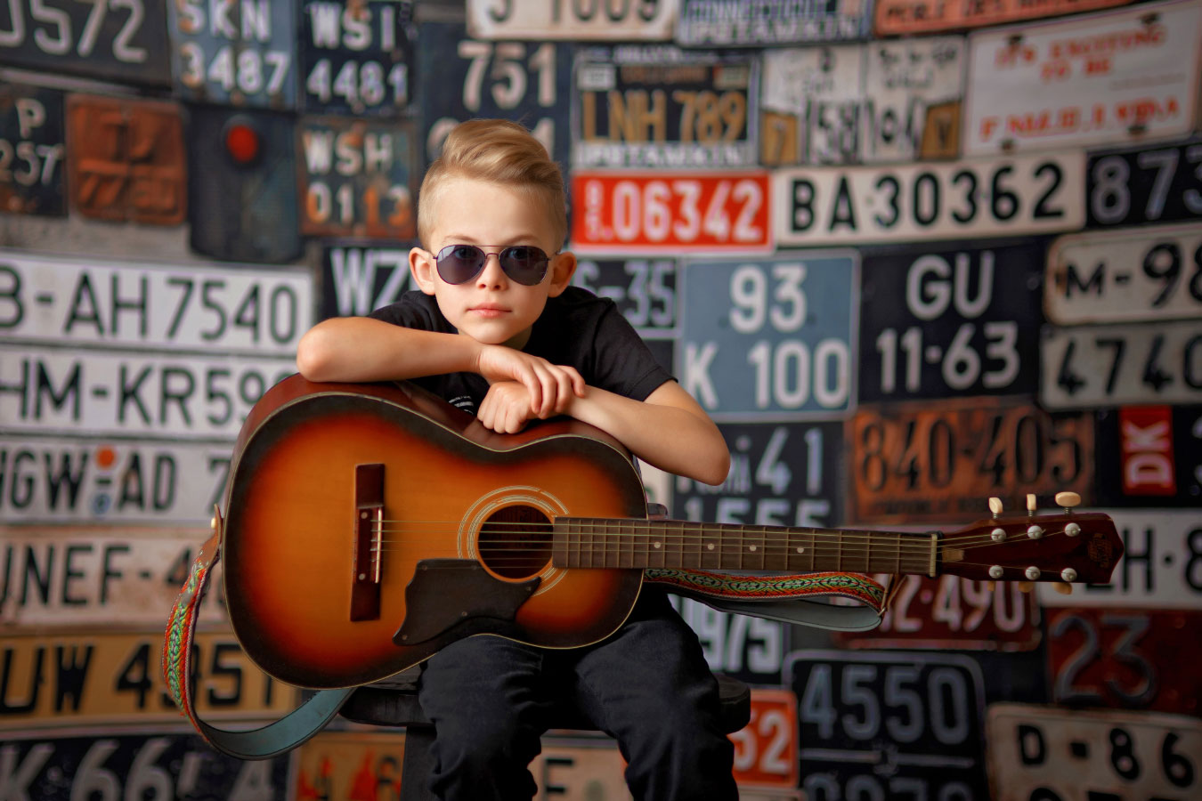 Atlanta children's photographer, kid in sunglasses with acoustic guitar in studio