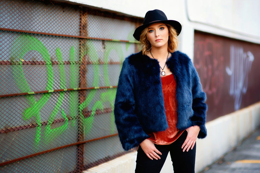 Atlanta senior portrait photographer, teen in hat by graffiti wall