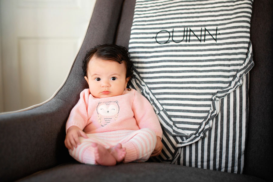 Powder Springs baby photographer, girl in chair during in-home session
