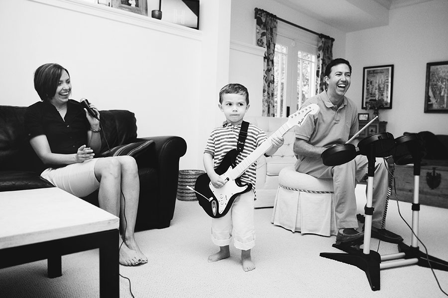 Powder Springs family photographer, lifestyle photography, playing Guitar Hero at home