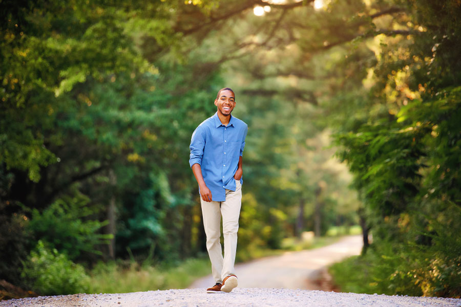 senior portrait photographer near Atlanta, teen boy walking down country road