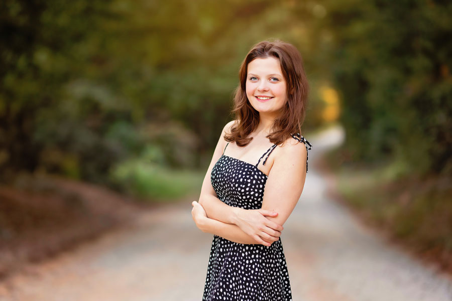 senior portrait photographer near Carrollton, GA; teen girl outside on country road