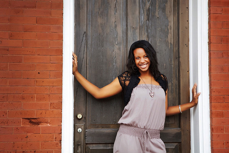 senior portrait photographer near Villa Rica, teen standing in doorway downtown