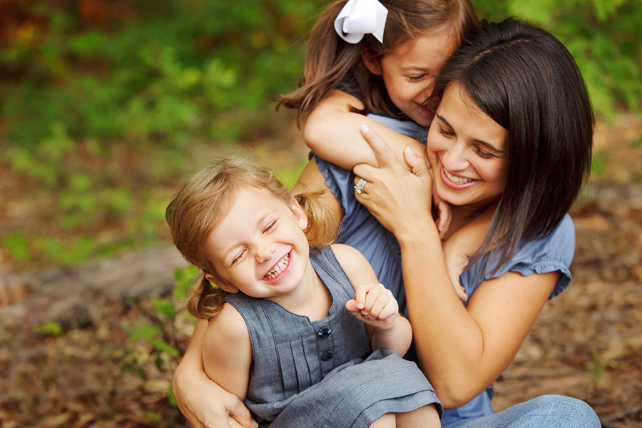 Tyrone family photographer, mommy and me with girls hugging mom outside