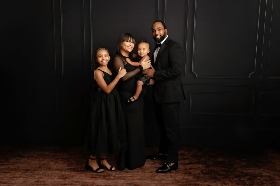 Villa Rica family photographer, formal studio portrait on black backdrop