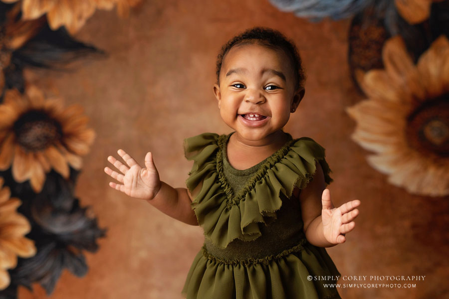 Atlanta baby photographer, smiling girl with sunflower backdrop