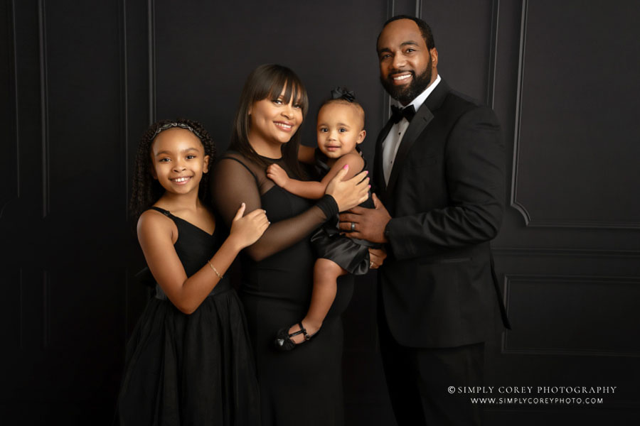 Douglasville family photographer, studio portrait on black backdrop