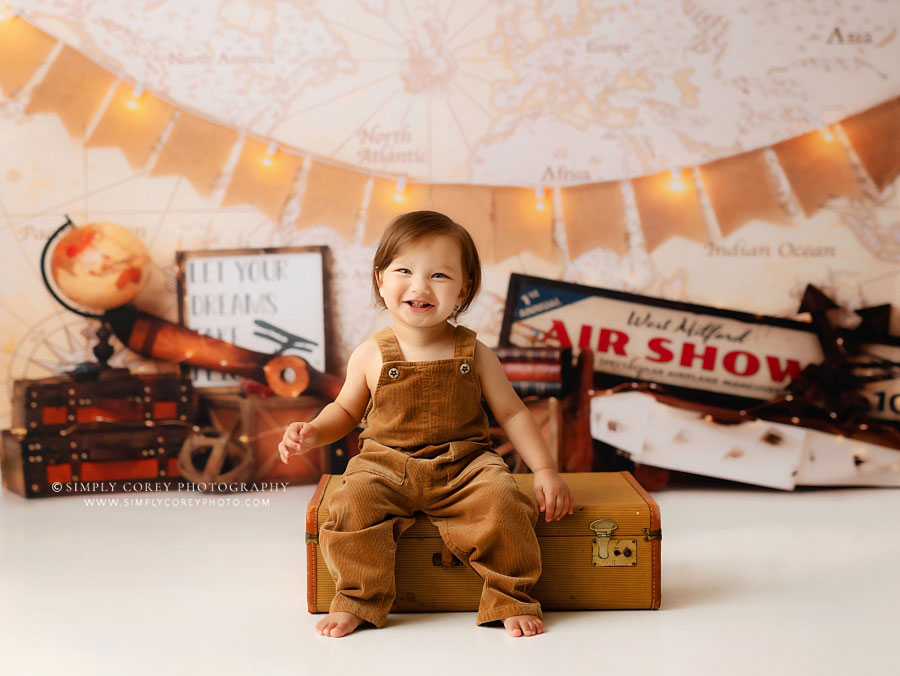 baby photographer near Atlanta, boy with suitcase on travel studio set