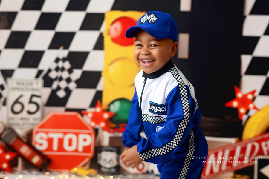 children's photographer near Newnan, child on race car studio set for fourth birthday