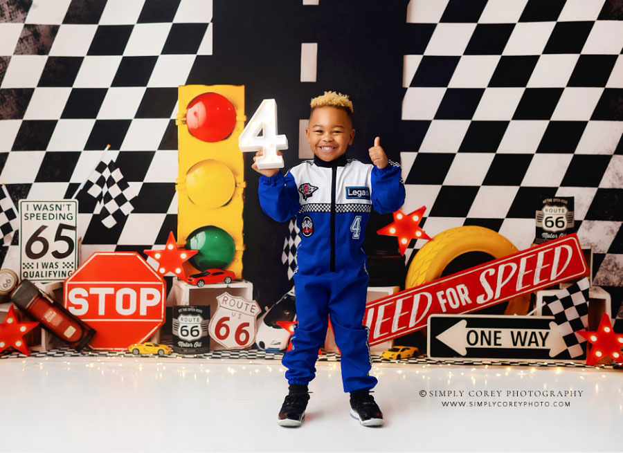 children's photographer near Villa Rica, boy with marquee 4 on race car studio set