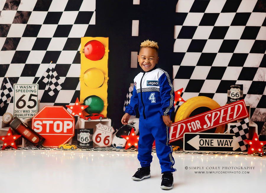 Douglasville kids photographer, child in race car uniform for birthday photos