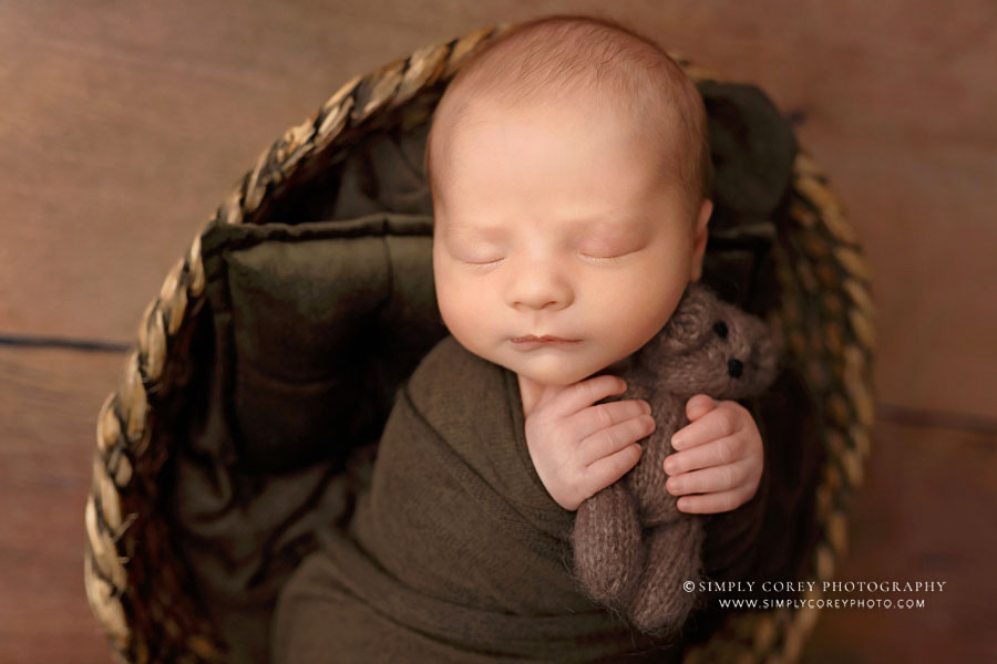 Carrollton newborn photographer in GA, baby boy in dark green with teddy bear
