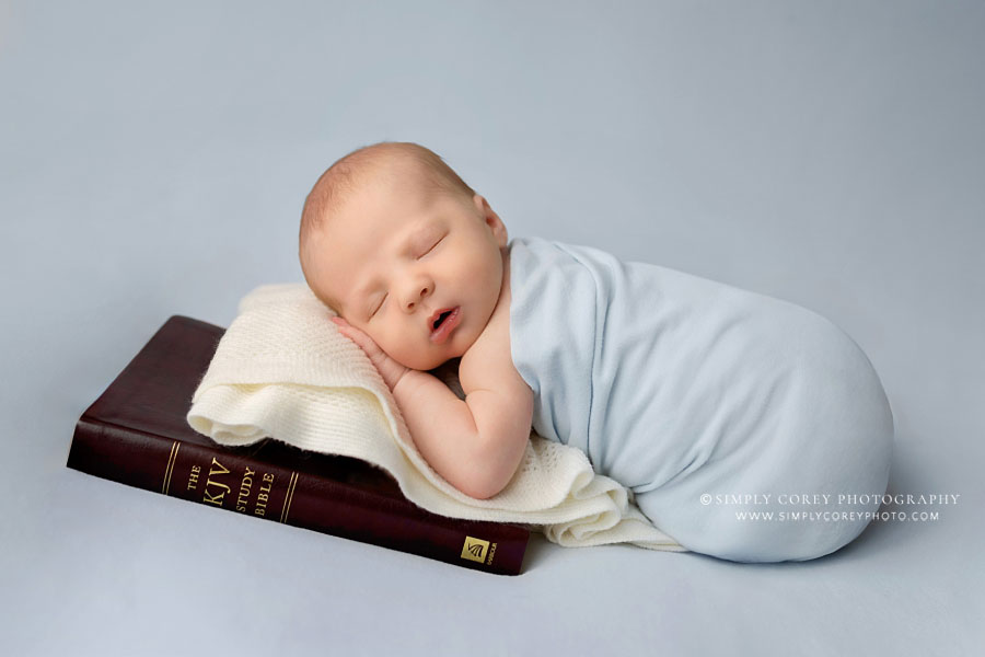 newborn photographer near Atlanta, baby boy in light blue with Bible