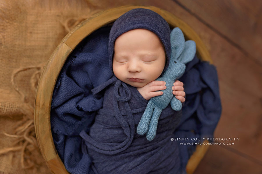 newborn photographer near Carrollton, GA; baby boy in blue with bunny