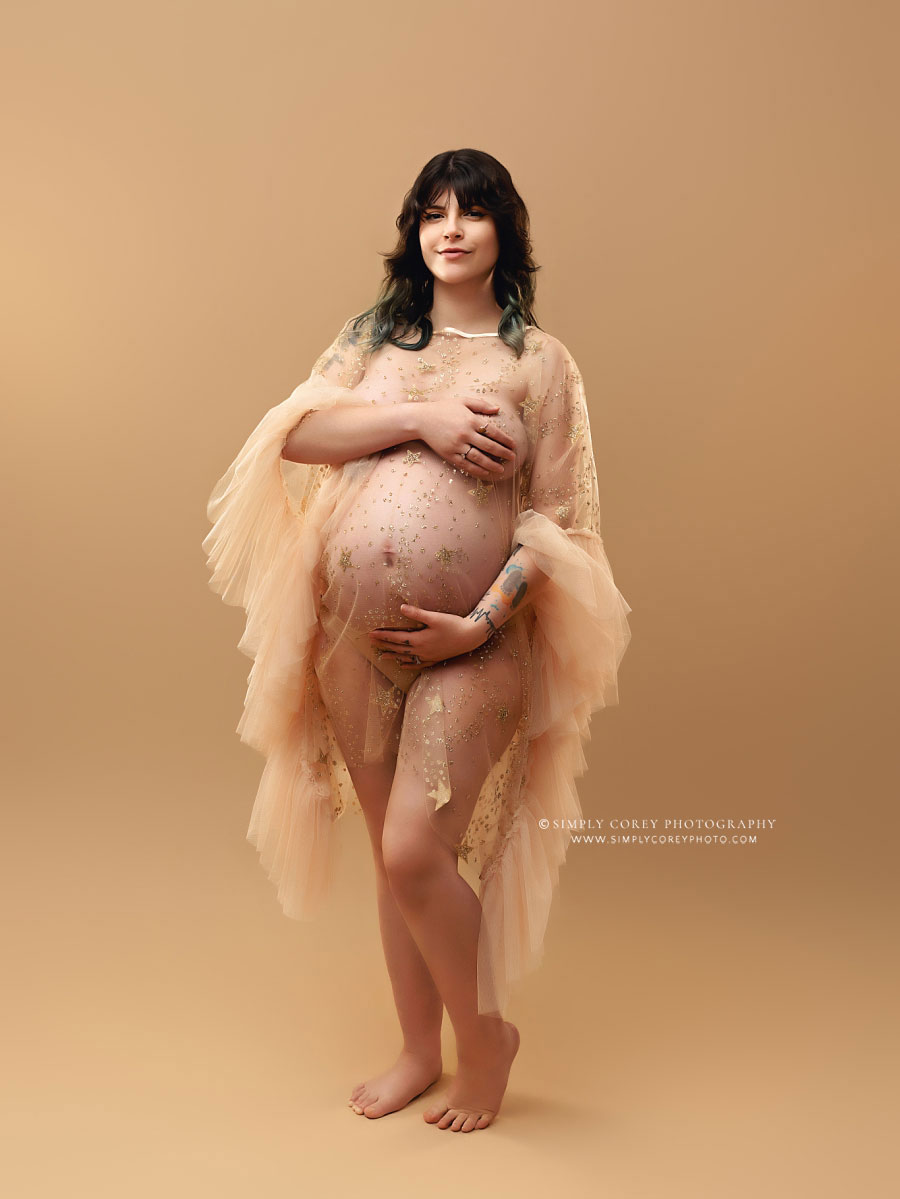 Newnan maternity photographer, mom in sheer dress with pecan studio backdrop